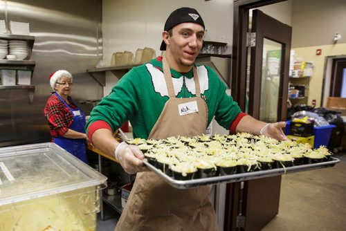 MIKE DEAL / WINNIPEG FREE PRESS
The Siloam Mission Christmas Eve meal serves over 600 people with anywhere from 65-100 volunteers to help make it happen on Monday December 24, 2018.
Volunteer Nick Franklin with a tray full of coleslaw just before service begins at noon.
181224 - Monday, December 24, 2018.
