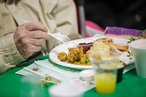 MIKE DEAL / WINNIPEG FREE PRESS
The Siloam Mission Christmas Eve meal serves over 600 people with anywhere from 65-100 volunteers to help make it happen on Monday December 24, 2018.
Carroll Caron digs into her turkey dinner.
181224 - Monday, December 24, 2018.