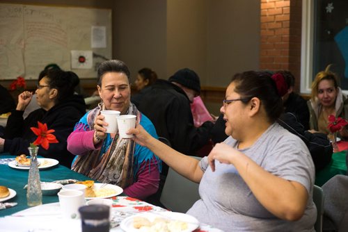 MIKAELA MACKENZIE / WINNIPEG FREE PRESS
Mary Graham (left) and Diana Atkinson say cheers at the annual Christmas lunch hosted by the West Broadway Community Ministry and Shaarey Zedek at Crossways in Common in Winnipeg on Tuesday, Dec. 25, 2018. 
Winnipeg Free Press 2018.