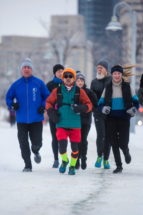 MIKAELA MACKENZIE / WINNIPEG FREE PRESS
Junel Malapad (centre, in red shorts) runs with supporters in his attempt to run 241 kilometres over the next three days, hoping to raise $5,000 for Siloam Mission, in Winnipeg on Wednesday, Dec. 26, 2018. 
Winnipeg Free Press 2018.