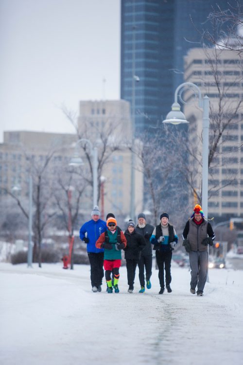 MIKAELA MACKENZIE / WINNIPEG FREE PRESS
Junel Malapad (centre, in red shorts) runs with supporters in his attempt to run 241 kilometres over the next three days, hoping to raise $5,000 for Siloam Mission, in Winnipeg on Wednesday, Dec. 26, 2018. 
Winnipeg Free Press 2018.