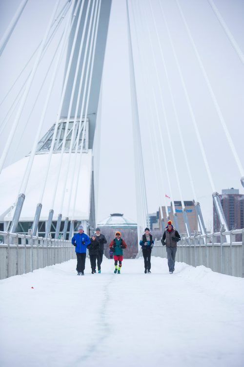 MIKAELA MACKENZIE / WINNIPEG FREE PRESS
Junel Malapad (centre, in red shorts) runs with supporters in his attempt to run 241 kilometres over the next three days, hoping to raise $5,000 for Siloam Mission, in Winnipeg on Wednesday, Dec. 26, 2018. 
Winnipeg Free Press 2018.