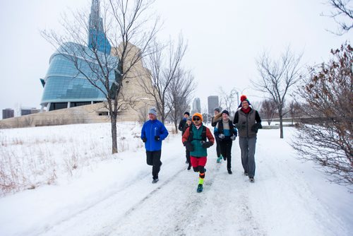 MIKAELA MACKENZIE / WINNIPEG FREE PRESS
Junel Malapad (centre, in red shorts) runs with supporters in his attempt to run 241 kilometres over the next three days, hoping to raise $5,000 for Siloam Mission, in Winnipeg on Wednesday, Dec. 26, 2018. 
Winnipeg Free Press 2018.