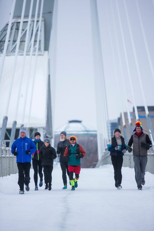 MIKAELA MACKENZIE / WINNIPEG FREE PRESS
Junel Malapad (centre, in red shorts) runs with supporters in his attempt to run 241 kilometres over the next three days, hoping to raise $5,000 for Siloam Mission, in Winnipeg on Wednesday, Dec. 26, 2018. 
Winnipeg Free Press 2018.