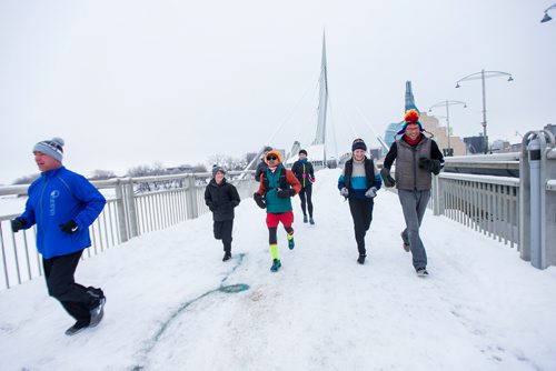 MIKAELA MACKENZIE / WINNIPEG FREE PRESS
Junel Malapad (centre, in red shorts) runs with supporters in his attempt to run 241 kilometres over the next three days, hoping to raise $5,000 for Siloam Mission, in Winnipeg on Wednesday, Dec. 26, 2018. 
Winnipeg Free Press 2018.