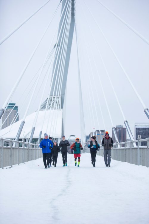 MIKAELA MACKENZIE / WINNIPEG FREE PRESS
Junel Malapad (centre, in red shorts) runs with supporters in his attempt to run 241 kilometres over the next three days, hoping to raise $5,000 for Siloam Mission, in Winnipeg on Wednesday, Dec. 26, 2018. 
Winnipeg Free Press 2018.