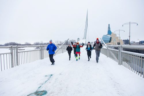 MIKAELA MACKENZIE / WINNIPEG FREE PRESS
Junel Malapad (centre, in red shorts) runs with supporters in his attempt to run 241 kilometres over the next three days, hoping to raise $5,000 for Siloam Mission, in Winnipeg on Wednesday, Dec. 26, 2018. 
Winnipeg Free Press 2018.