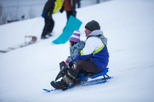 MIKAELA MACKENZIE / WINNIPEG FREE PRESS
Alexander Arellano and his daughter, Eunice (five) toboggan at West View Park in Winnipeg on Wednesday, Dec. 26, 2018. 
Winnipeg Free Press 2018.