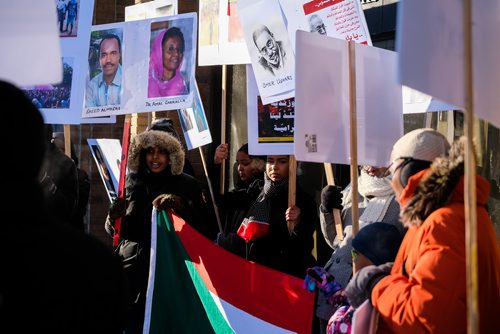 Daniel Crump / Winnipeg Free Press
 Sahaiba Ahmed (left) holds a sign, and a sudanese flag as she chants, while taking part in a protest outside MP Jim Carrs office (611 Corydon Ave.) in solidarity with the recent protests in Sudan. 
December 28, 2018.