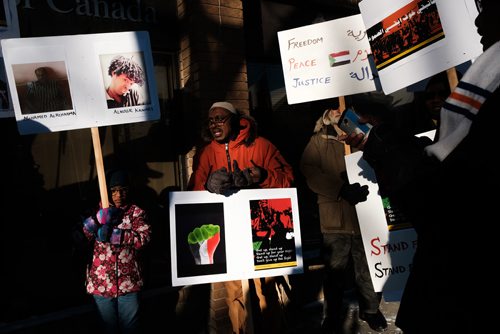 Daniel Crump / Winnipeg Free Press
 Mekki Mohamed (centre) leads chants as he takes part in a protest outside MP Jim Carrs office (611 Corydon Ave.) in solidarity with the recent protests in Sudan. 
December 28, 2018.