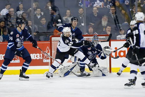 JOHN WOODS / WINNIPEG FREE PRESS
Manitoba Moose Logan Stanley (7) defends against Colorado Eagles' Cody Bass (45) in front Moose goaltender Eric Comrie (1) during second period AHL action in Winnipeg on Sunday, December 30, 2018.