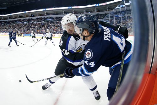 JOHN WOODS / WINNIPEG FREE PRESS
Manitoba Moose Brent Pedersen (44) gets the pass away as Colorado Eagles' Kevin Davis (82) attempts the check during second period AHL action in Winnipeg on Sunday, December 30, 2018.