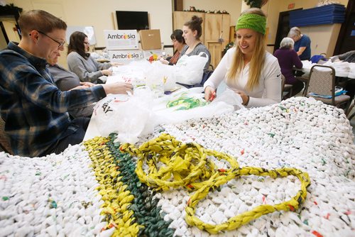 JOHN WOODS / WINNIPEG FREE PRESS
Tessa Blaikie Whitecloud, executive director of 1JustCity, right, makes blankets and sleeping mats out of plastic shopping bags with volunteers for people living on the streets at Oak Table Sunday, December 30, 2018. On Tuesday Just a Warm Sleep will open to offer up to 25 people a safe place to sleep.