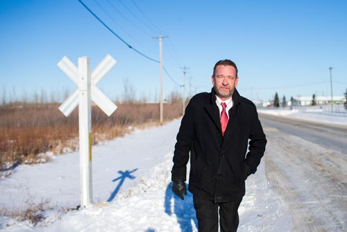 MIKAELA MACKENZIE / WINNIPEG FREE PRESS
Neil Greenslade, a Winnipegger who served as assistant superintendent with Canadian Pacific for three decades, poses by the tracks in Winnipeg on Monday, Dec. 31, 2018. 
Winnipeg Free Press 2018.