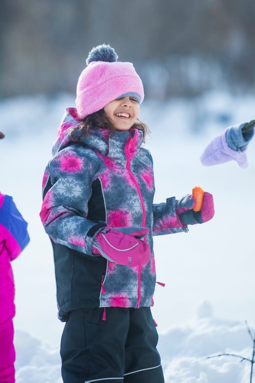 MIKAELA MACKENZIE / WINNIPEG FREE PRESS
Amelia Happychuk (five) laughs as she tries to high five the snowman she made with their dad at St. Vital Park in Winnipeg on Thursday, Jan. 3, 2019. 
Winnipeg Free Press 2018.