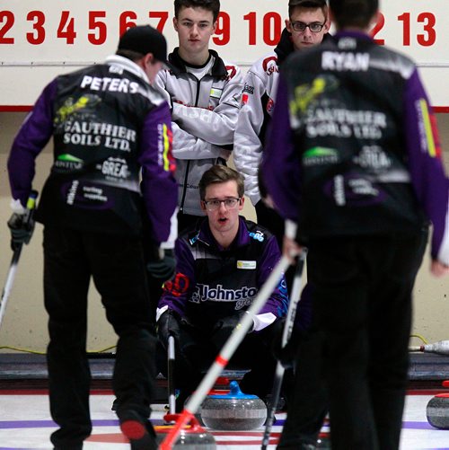 PHIL HOSSACK / WINNIPEG FREE PRESS -JT Ryan's third Jacques Gauthier (centre) guides his skip's rock against Ghislain Courcelles' rink Thursday at the Heather Curling Club.  See Mike Sawatzky story. - January 3, 2019.