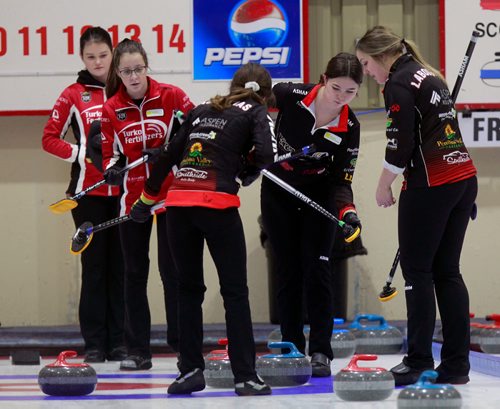 PHIL HOSSACK / WINNIPEG FREE PRESS -Mackenzie Zacharias third Lauryn Kuzyk watches the flow as sweepers Caitlyn Laboissier (right) and Emily Zacharias b ring the stone home Thursday at the Heather Curling Club.  Opposing skip Emma Jensen (left) and third Jaycee Terrick follow from behind the play. See Mike Sawatzky story. - January 3, 2019.
