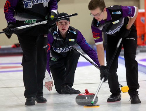 PHIL HOSSACK / WINNIPEG FREE PRESS -JT Ryan keeps a close eye on his rock as Jacques Gauthier (right) and Jordan Peters sweep against Ghislain Courcelles' rink Thursday at the Heather Curling Club.  See Mike Sawatzky story. - January 3, 2019.