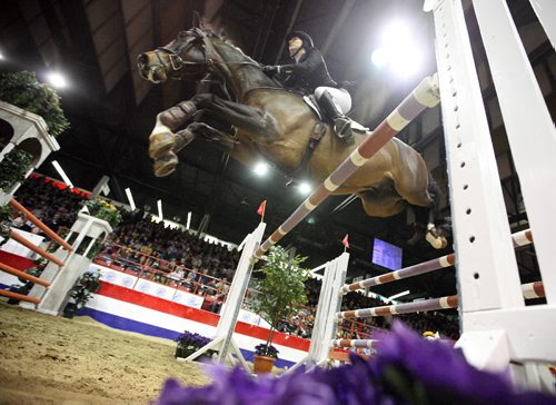 Brandon Sun 04042009 Tamie Phillips of Strathmore, AB, leaps over an obstacle atop Santos during her run at  the MTS Allstream Grand Prix at the Royal Manitoba Winter Fair in Brandon on Saturday evening. (Tim Smith/Brandon Sun)