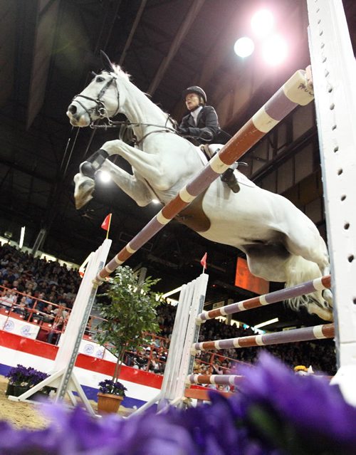 Brandon Sun 04042009 Karen Cudmore of Omaha leaps over an obstacle atop Platinum during her run at  the MTS Allstream Grand Prix at the Royal Manitoba Winter Fair in Brandon on Saturday evening. (Tim Smith/Brandon Sun)