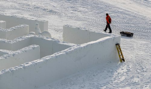 MIKE DEAL / WINNIPEG FREE PRESS
An employee takes chopped wood out to one of the fire pits the day before the big grand opening.
Clint and Angie Masse who own A Maze in Corn near St. Adolphe have constructed a maze made of snow they hope will break a world record.
190104 - Friday, January 04, 2019.