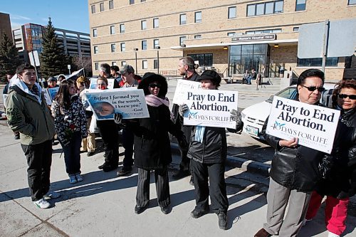 BORIS MINKEVICH / WINNIPEG FREE PRESS  090405 (centre two) Myrna Howard (with pick scarf on facing towards the camera from the left) and Barbara Olson (wearing a black hat facing the camera holding up the sign &quot;Pray to End Abortion&quot;). They were there part of the closing rally for the Winnipeg event called &quot;40 Days of Life&quot;. Photo taken in front of the Women's Hospital on Notre Dame.