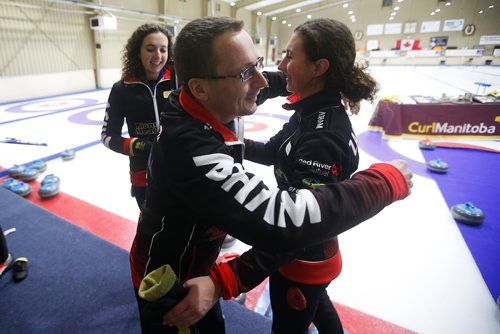 JOHN WOODS / WINNIPEG FREE PRESS
Mackenzie, left, and Emily Zacharias are hugged by their dad and coach Sheldon Zacharias as her team defeated Meghan Walter in the Manitoba Junior Championships Monday, January 6, 2019.