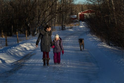 PHIL HOSSACK / Winnipeg Free Press - Petra McGowan and her daughter Emerson walk down the driveway to where Emerson catches the school bus at their St Anne Manitoba home Wednesday, Petra would like to see seatbelts on school buses. See story.  January 9, 2019.
