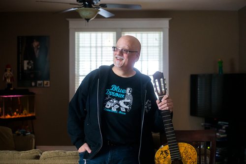 MIKAELA MACKENZIE / WINNIPEG FREE PRESS
Stu Reid poses for a portrait in the "Stu Dome," also known as his living room, where he hosts frequent house concerts in Winnipeg on Thursday, Jan. 10, 2019. The guitar has been signed by all of the performers he's had in his home (the strings had to be taken off to make room for more signatures).
Winnipeg Free Press 2018.