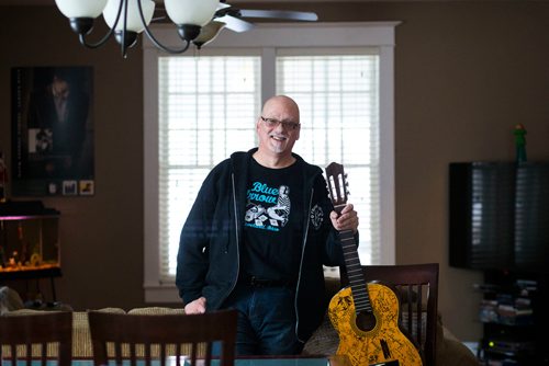 MIKAELA MACKENZIE / WINNIPEG FREE PRESS
Stu Reid poses for a portrait in the "Stu Dome," also known as his living room, where he hosts frequent house concerts in Winnipeg on Thursday, Jan. 10, 2019. The guitar has been signed by all of the performers he's had in his home (the strings had to be taken off to make room for more signatures).
Winnipeg Free Press 2018.