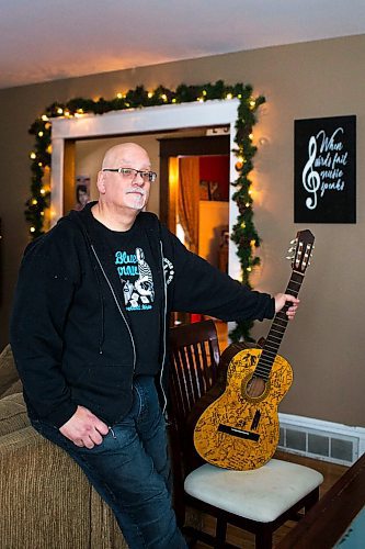 MIKAELA MACKENZIE / WINNIPEG FREE PRESS
Stu Reid poses for a portrait in the "Stu Dome," also known as his living room, where he hosts frequent house concerts in Winnipeg on Thursday, Jan. 10, 2019. The guitar has been signed by all of the performers he's had in his home (the strings had to be taken off to make room for more signatures).
Winnipeg Free Press 2018.