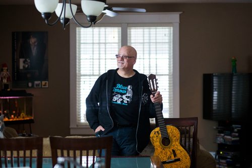 MIKAELA MACKENZIE / WINNIPEG FREE PRESS
Stu Reid poses for a portrait in the "Stu Dome," also known as his living room, where he hosts frequent house concerts in Winnipeg on Thursday, Jan. 10, 2019. The guitar has been signed by all of the performers he's had in his home (the strings had to be taken off to make room for more signatures).
Winnipeg Free Press 2018.