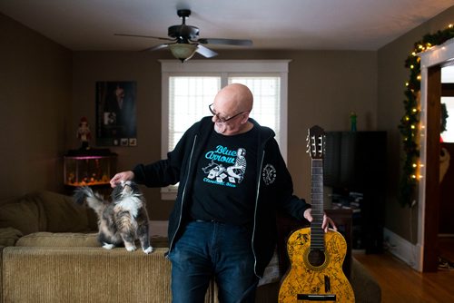 MIKAELA MACKENZIE / WINNIPEG FREE PRESS
Stu Reid poses for a portrait in the "Stu Dome," also known as his living room, where he hosts frequent house concerts in Winnipeg on Thursday, Jan. 10, 2019. The guitar has been signed by all of the performers he's had in his home (the strings had to be taken off to make room for more signatures).
Winnipeg Free Press 2018.