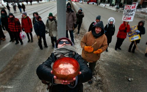 PHIL HOSSACK / WINNIPEG FREE PRESS - Roxie Vincent holds a ceremonial copper bowl of water as Protestors dance at Portage and Main Thursday. See Kevin Rollason's story.  January 10, 2019