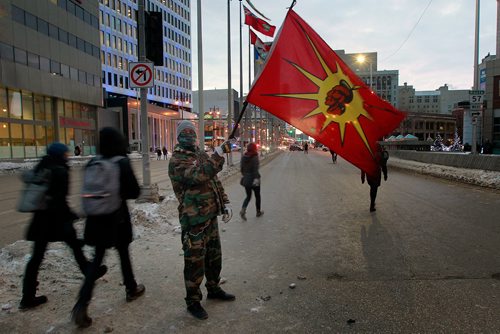 PHIL HOSSACK / WINNIPEG FREE PRESS - An AIM warrior shows the flag at Portage and Main as the rush hour protest winds down Thursday. See Kevin Rollason's story.  January 10, 2019