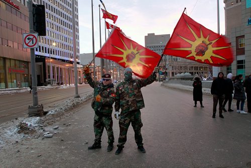 PHIL HOSSACK / WINNIPEG FREE PRESS - A pair of Warriors show the AIM Flag at Portage and Main Thursday. See Kevin Rollason's story.  January 10, 2019