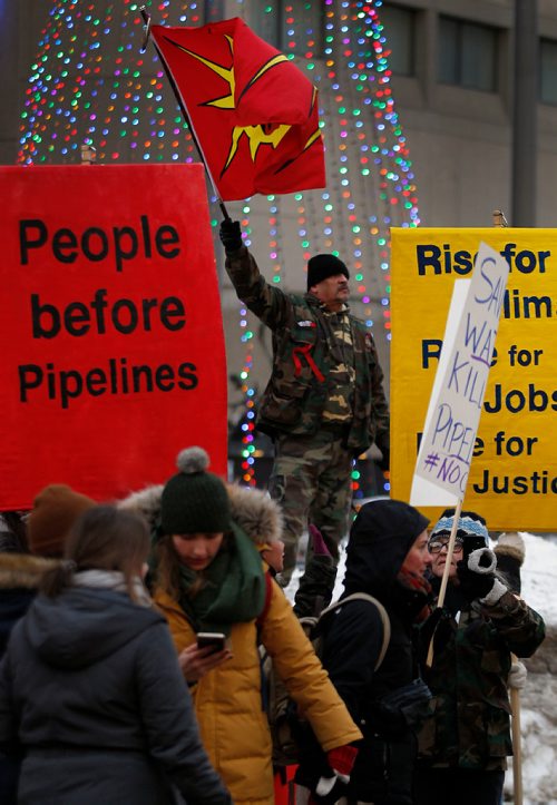 PHIL HOSSACK / WINNIPEG FREE PRESS - An AIM warrior flies the flag at Portage and Main Thursday. See Kevin Rollason's story. January 10, 2019