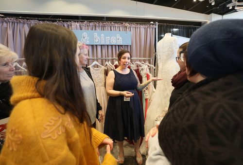 RUTH BONNEVILLE / WINNIPEG FREE PRESS

Amanda  Murdock owner of pearl & birch wedding consignment store, shows potential clients her dresses at her booth at the  The Wonderful Wedding Show at RBC Convention Centre, Saturday. 

Jan 19th, 2019 
