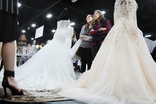 RUTH BONNEVILLE / WINNIPEG FREE PRESS

Bride-to-be, Brittany Barman and her mom Mary Bartman, gaze at wedding dresses designed by Anna Lang Bridal The Wonderful Wedding Show at RBC Convention Centre, Saturday. 

Jan 19th, 2019 
