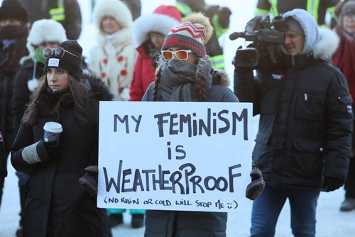 RUTH BONNEVILLE / WINNIPEG FREE PRESS

Renee Desjardins holds a sign that says "My Feminism is Weatherproof" as she listens to speeches with other people in bitter temperatures in support of Women's rights during the annual Women's Day March at the Legislative grounds Saturday. 

Jan 19th, 2019 
