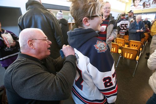 JOHN WOODS / WINNIPEG FREE PRESS
Former Winnipeg Jet Joe Daley signs a jersey for Shaw Jacob at a mural unveiling in Daley's honour at the Bronx Community Centre in Winnipeg  Sunday, January 20, 2019.