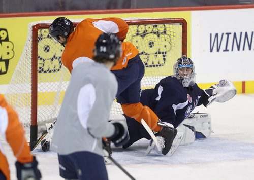 TREVOR HAGAN / WINNIPEG FREE PRESS
Manitoba Moose goaltender Eric Comrie (1) with Chris Collins (46) in front during practice at Bell MTS Place, Monday, January 21, 2019.