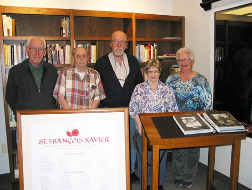 Canstar Community News Jan. 16, 2019 - St. Francois Xavier Historical Society members (from left) Rudy Friesen, Ed Owchar, Keven Van Camp, Jean Owchar and Levina Cunningham are shown with the scroll listing local veterans' names and the album filled with veterans' photos. (ANDREA GEARY/CANSTAR COMMUNITY NEWS)