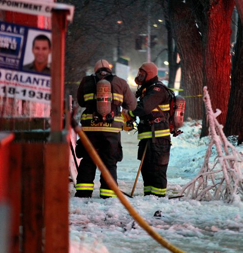 PHIL HOSSACK / WINNIPEG FREE PRESS - City firefighters don breathing apparatus to enter a three story apartment building during a mop up operation Monday. A second fire in the building in a week closed Maryland Street during the afternoon rush hour.-January 21, 2019. 

Note Also I photographed another serious fire at the same location a year maybe 2 ago......not sure of the date, there were injuries then and photos of at least one being taken away.