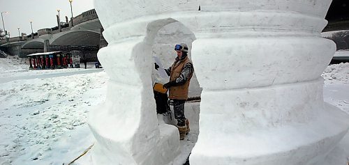 PHIL HOSSACK / WINNIPEG FREE PRESS - Snow Sculptor Jakobi Heinrichs checks the drawings as he puts the finishing touches on one of Architect Michael Maltzan's WAG Inuit Art Centre warming huts on the Red River Wednesday. See story. January 23, 2019