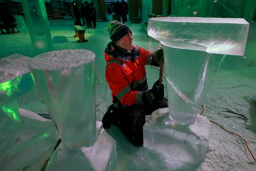 PHIL HOSSACK / WINNIPEG FREE PRESS - Luca Roncoroni puts the finishing touches on a set of luminescent bar tables at the opening night of the Ice Bar on the Red River Wednesday. Luca hails originally from Italy, now lives in Norway and makes the trip to Winnipeg every year to work on the trail's Warming Huts and features. See story. January 23, 2019