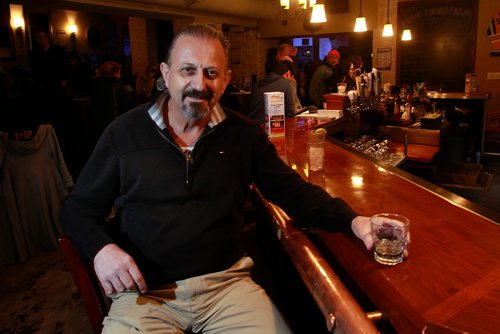 PHIL HOSSACK / WINNIPEG FREE PRESS - Wee Johnny's  owner John Giannakis sits at the bar in his basement comedy club under his restaurant Johnny G's. See story. January 23, 2019