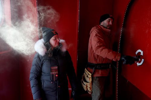 TREVOR HAGAN / WINNIPEG FREE PRESS
Winnipegers Jennie O'Keefe and Chris Pancoe inside the hut they designed called Huttie, a warming hut at The Forks, Friday, January 25, 2019. Chris is winding a crank that powers lights inside the hut.