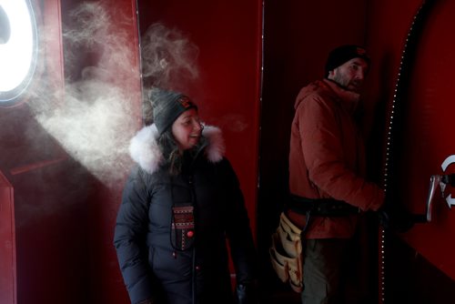 TREVOR HAGAN / WINNIPEG FREE PRESS
Winnipegers Jennie O'Keefe and Chris Pancoe inside the hut they designed called Huttie, a warming hut at The Forks, Friday, January 25, 2019. Chris is winding a crank that powers lights inside the hut.