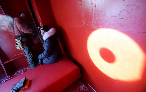 TREVOR HAGAN / WINNIPEG FREE PRESS
Winnipegers Chris Pancoe and Jennie O'Keefe inside Huttie, a warming hut at The Forks, Friday, January 25, 2019. Chris is winding a crank that powers lights inside the hut.